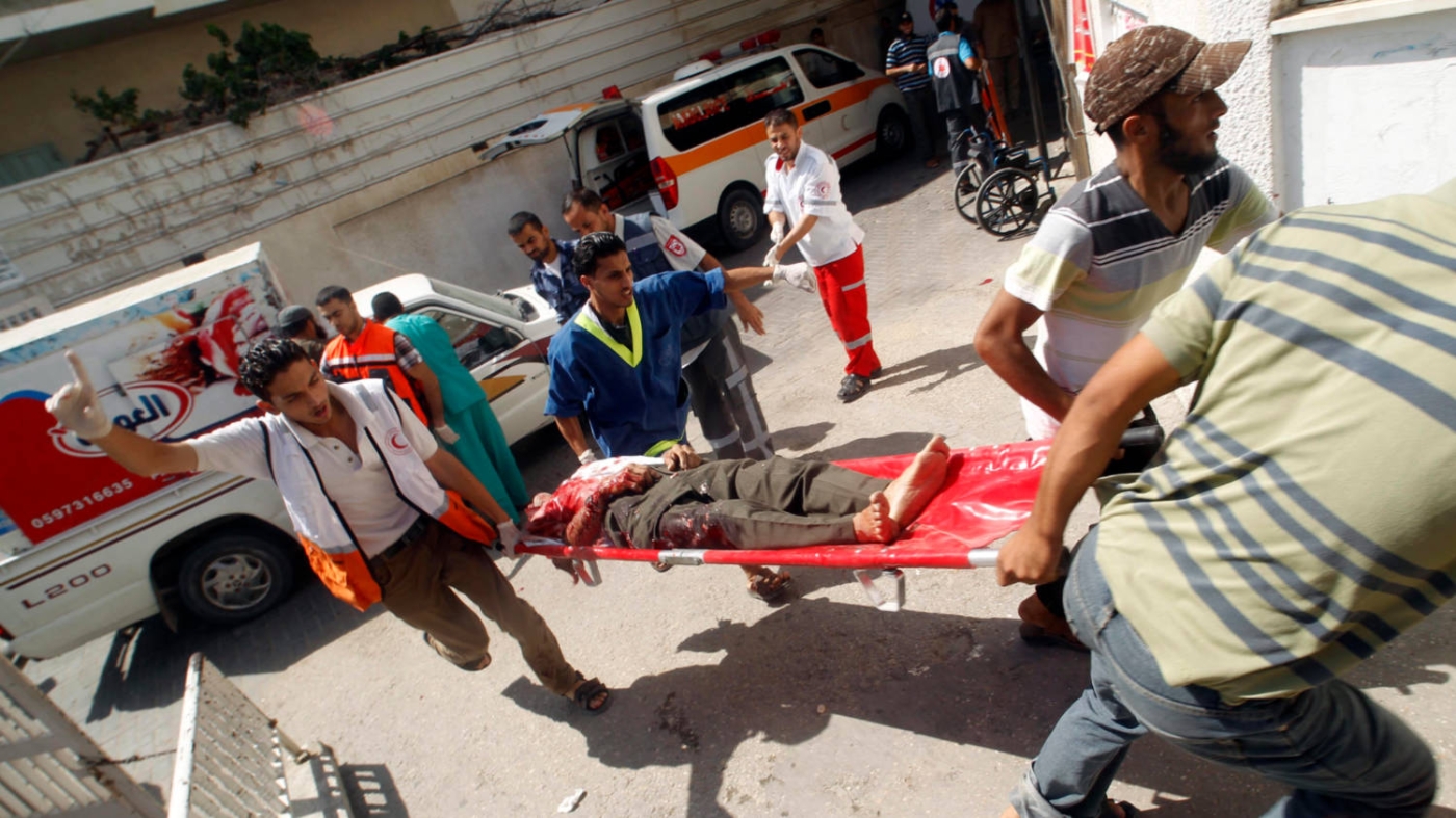 The body of a Palestinian man arrives at al-Najar hospital, Rafah, Gaza after the Israeli air strike of 1 August 2014