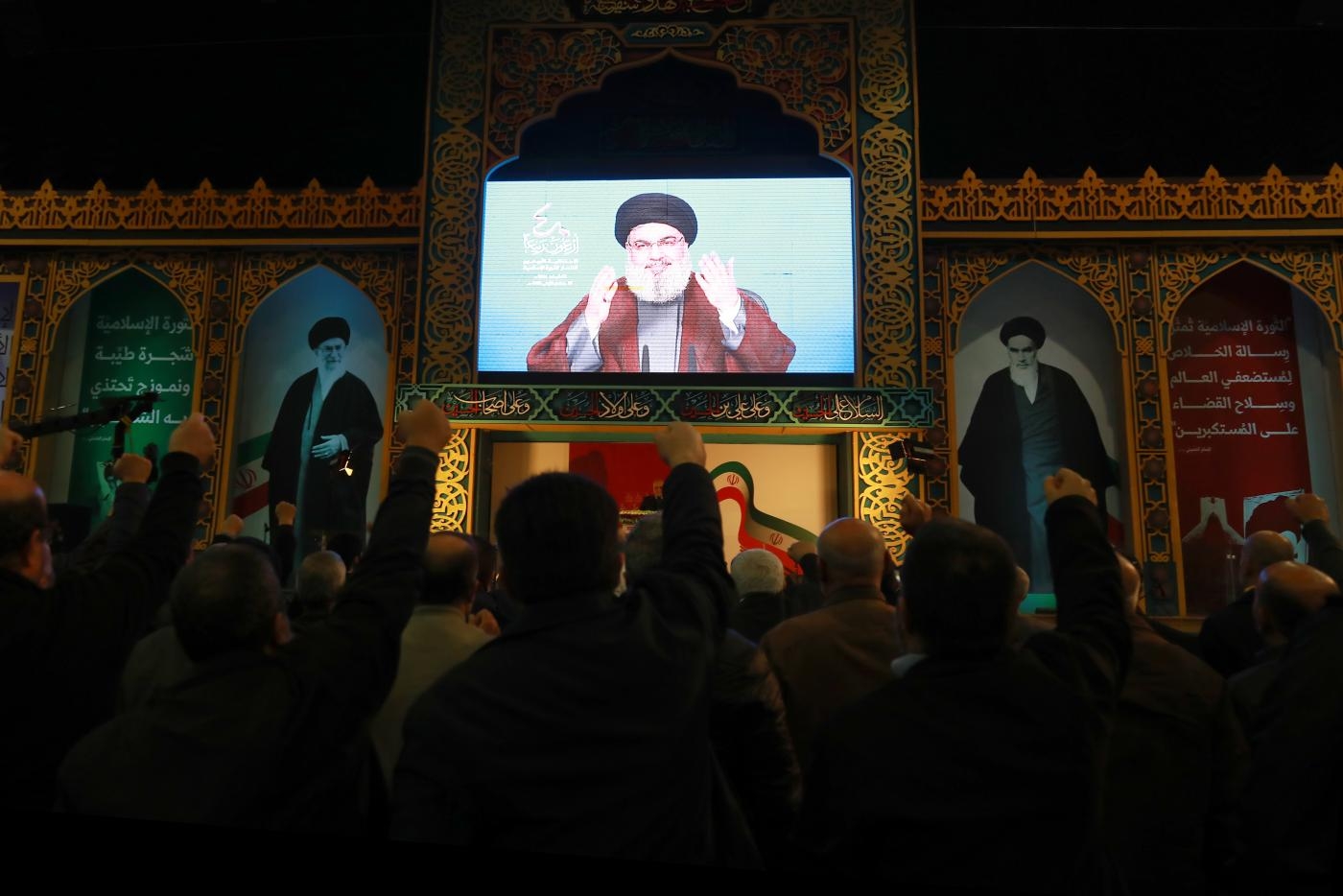 Hezbollah supporters listen to a speech by Secretary-General Hassan Nasrallah