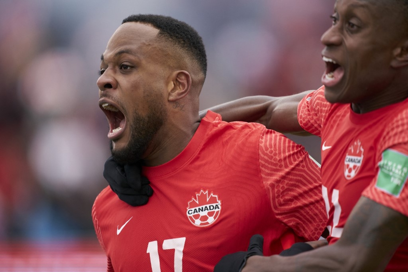 Canada’s Cyle Larin celebrates his goal with teammate Richie Laryea during their World Cup Qualifying match against Jamaica at BMO Field in Toronto on 27 March 2022. (AFP)