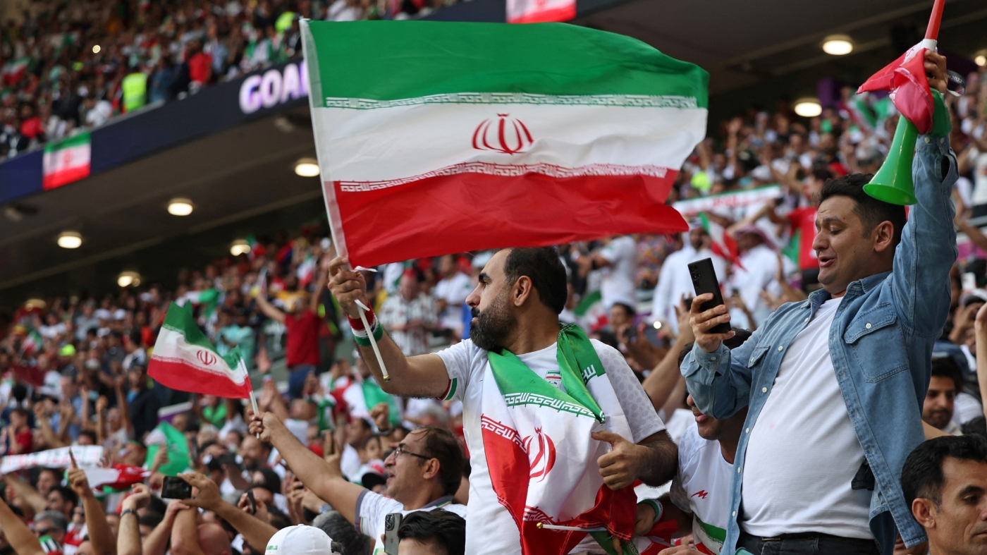 Iran's fans celebrate at the end of the Qatar 2022 World Cup Group B football match between Wales and Iran at the Ahmad Bin Ali Stadium in Al-Rayyan, west of Doha on 25 November 2022 (AFP)