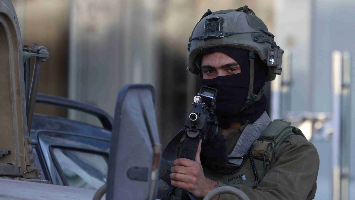 An Israeli soldier stands guard during an operation near the Jit junction west of Nablus in the occupied West Bank on 12 March 2023 (AFP)