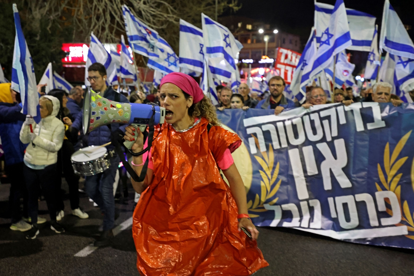 Protesters gather during a rally against the government's controversial judicial overhaul bill in Haifa on March 18, 2023 (AFP)