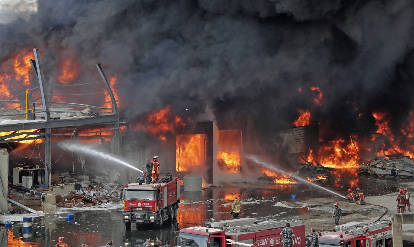 Lebanese firefighters try to put out a fire in Beirut's port area