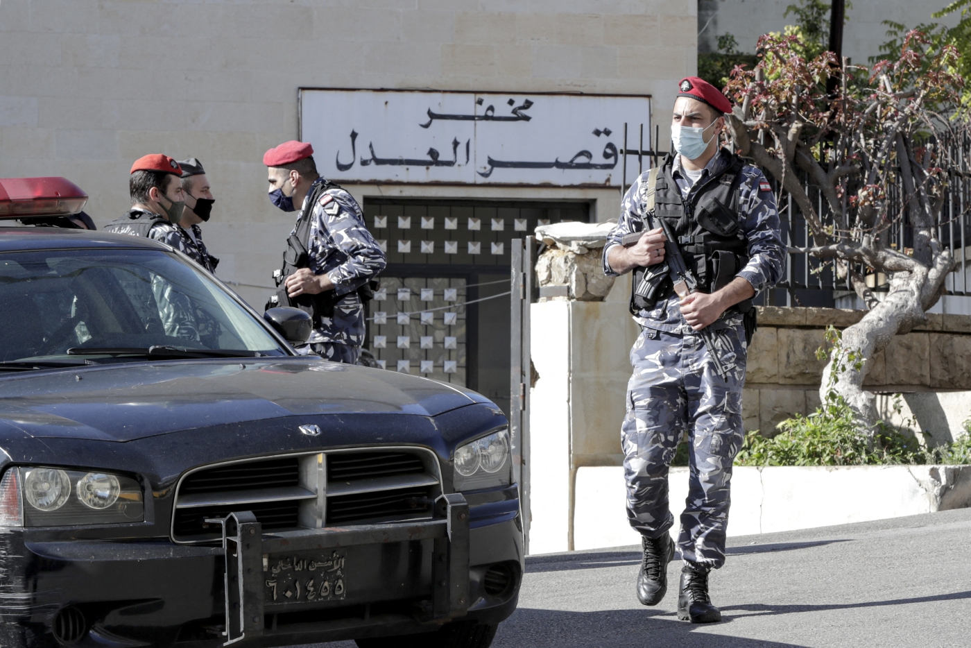 Police officers stand guard outside a detention centre outside Beirut