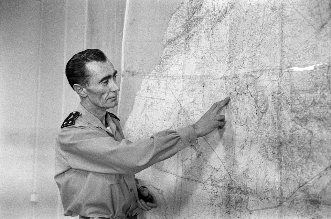 Photo prise à Reggane, dans le Sahara algérien, en décembre 1960 : le général Jean Thiry décrit aux journalistes l’explosion, le 27 décembre 1960, de la troisième bombe atomique française lors de l’opération dite « Gerboise rouge » (AFP)