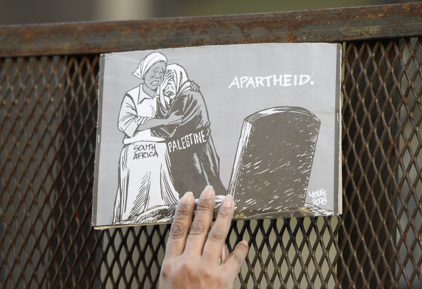 Une caricature contre l’apartheid et le racisme placée sur une barrière de sécurité, lors d’une manifestation devant l’ambassade israélienne, à Buenos Aires (Argentine), le 12 septembre 2017 (AFP)