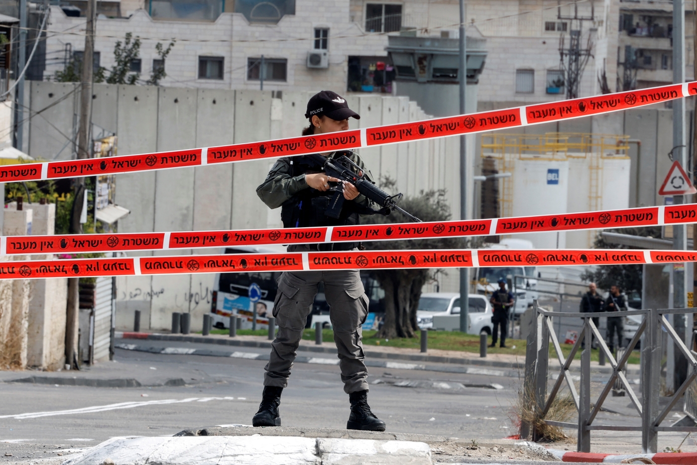 An Israeli soldier stands guard at the entrance to Shuafat refugee camp during a manhunt following a shooting incident at a check point in East Jerusalem 9 Octobe 2022 (Reuters)
