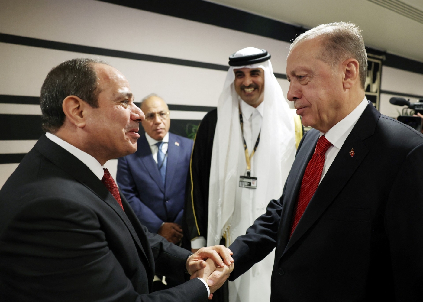 Turkey's President Recep Tayyip Erdogan shakes hands with his Egyptian counterpart Abdel Fattah el-Sisi on the sidelines of the World Cup opening ceremony in Doha (Reuters)
