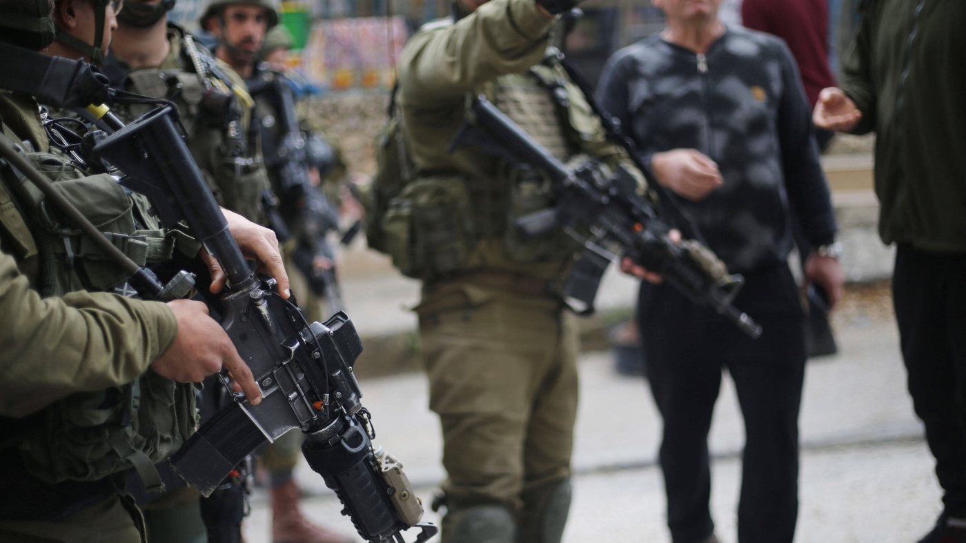 Israeli forces stand as they blocking the roads in the West Bank city of Nablus on 26 March 2023 (Reuters)
