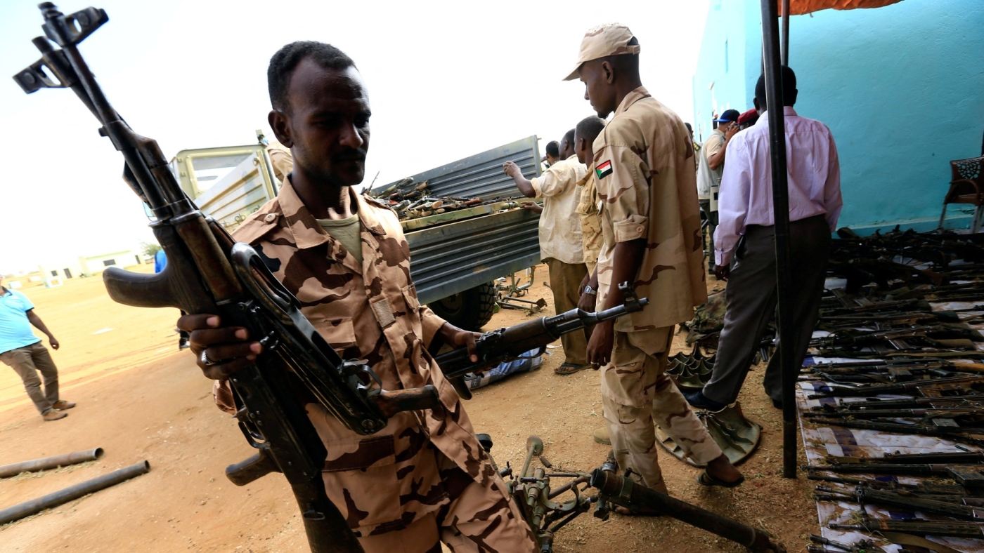 Rapid Support Forces fighters upload disarmed weapons in Umm Al-Qura, Darfur in 2017 (Reuters)