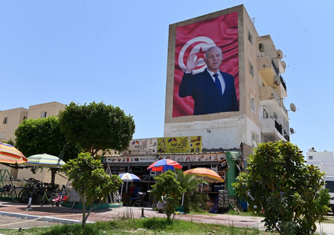 A billboard depicting Tunisia's President Kais Saied hangs on the side of a building in the east-central city of Kairouan, 26 July 2022 (AFP)