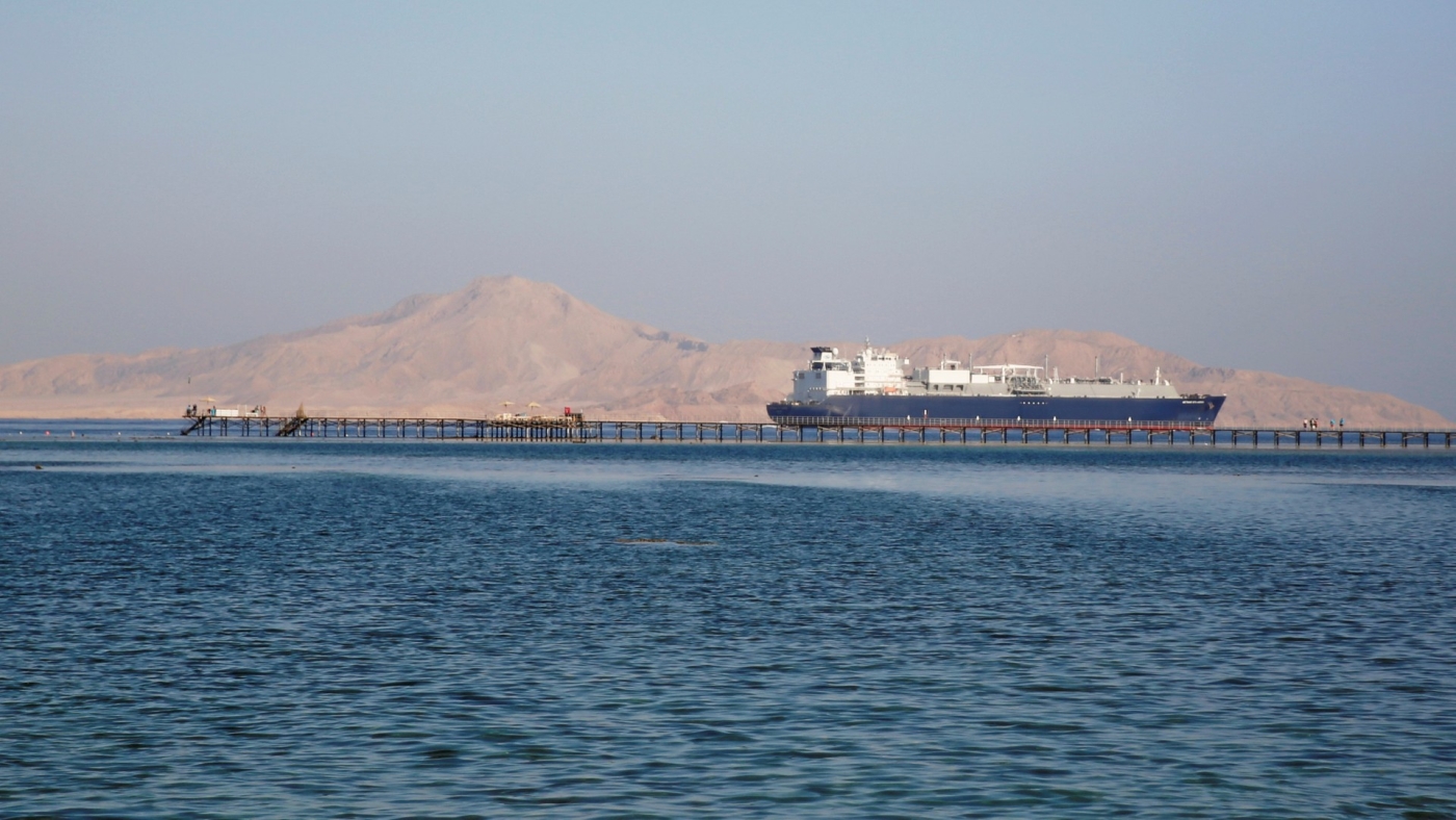 A container ship passes by a beach in the Aqaba Gulf in front of Tiran island on 12 July 2018.