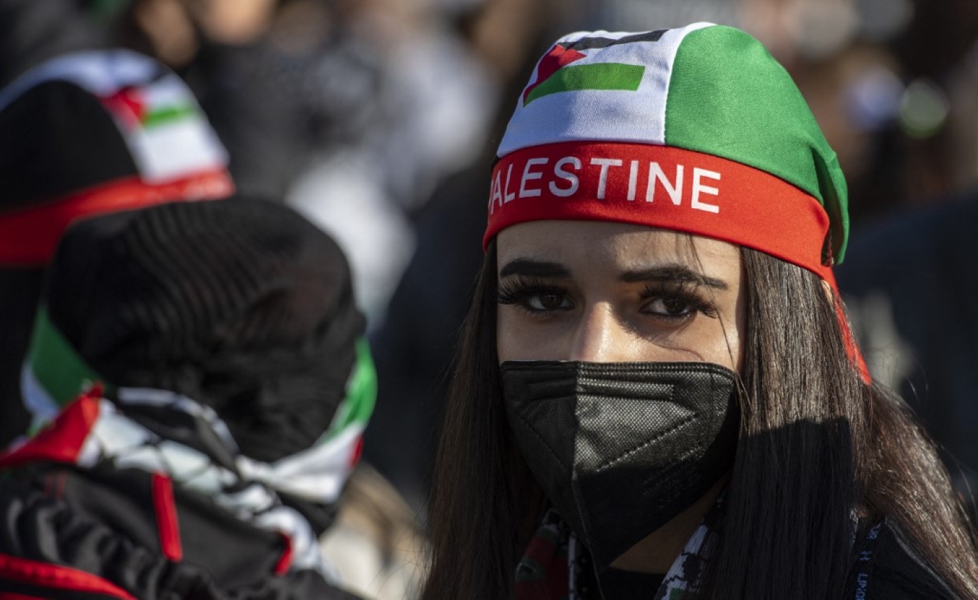 A demonstrator wears a cap in the colours of the Palestinian flag during a pro-Palestinian protest in Berlin on 19 May 2021 (AFP)