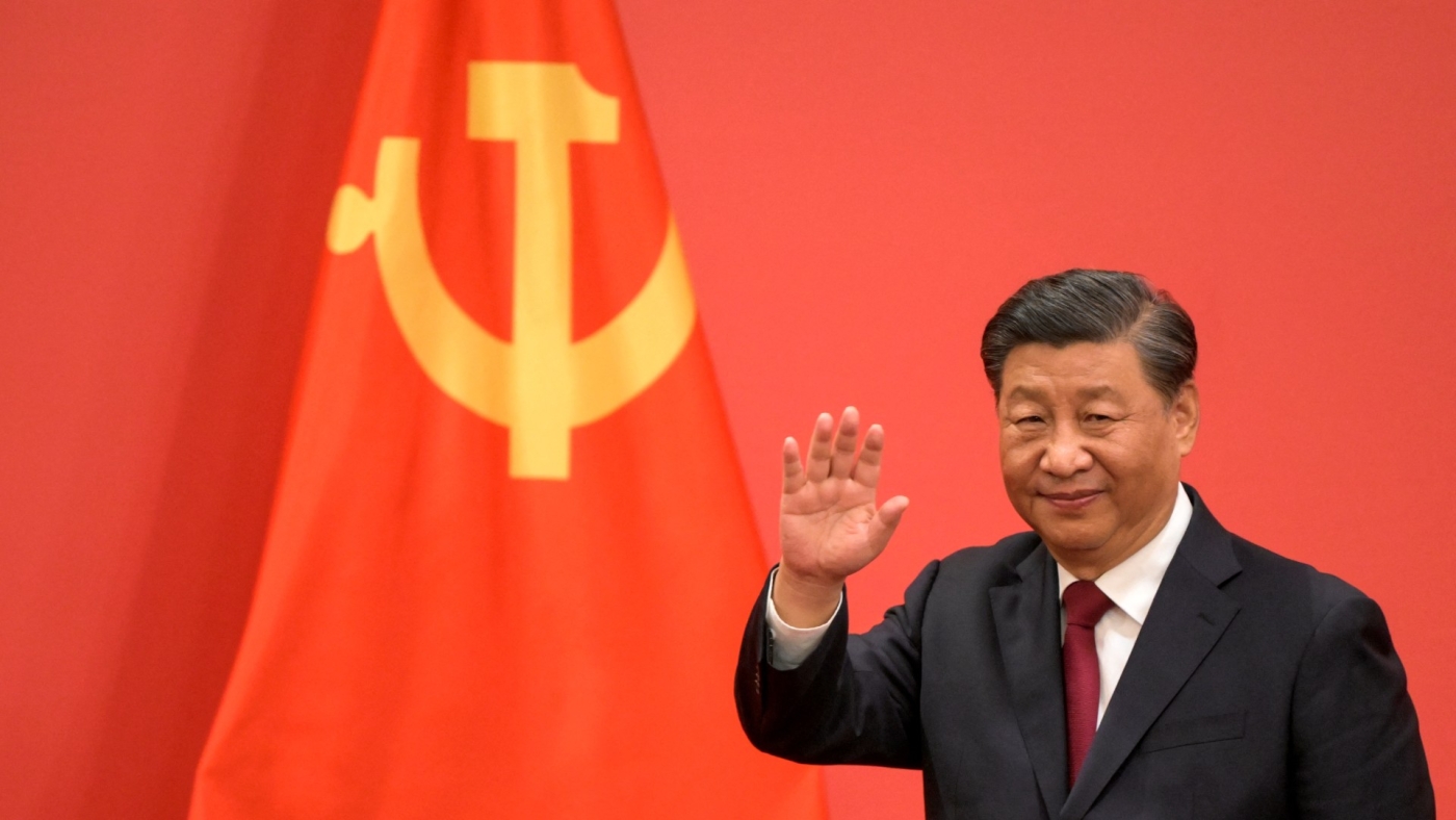 China's President Xi Jinping waves during the introduction of members of the Chinese Communist Party's new Politburo Standing Committee on 23 October, 2022 (AFP)