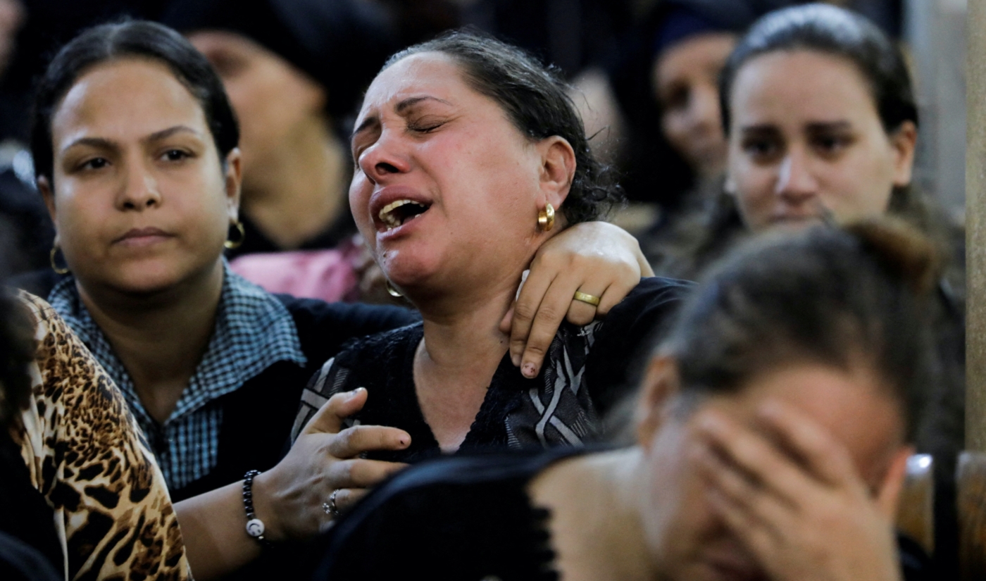A woman reacts during the funeral of victims who died in the fire that broke out at the Abu Sifin church, inside the Church of the Blessed Virgin Mary at Warraq Al Arab district in Giza Governorate, Egypt, 14 August 2022 
