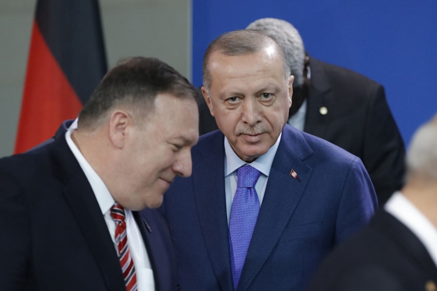 Turkish President Recep Tayyip Erdogan (C) looks on as then-US Secretary of State Mike Pompeo (L) walks past prior a family picture during a Peace summit on Libya at the Chancellery in Berlin, on January 19, 2020.  (AFP)