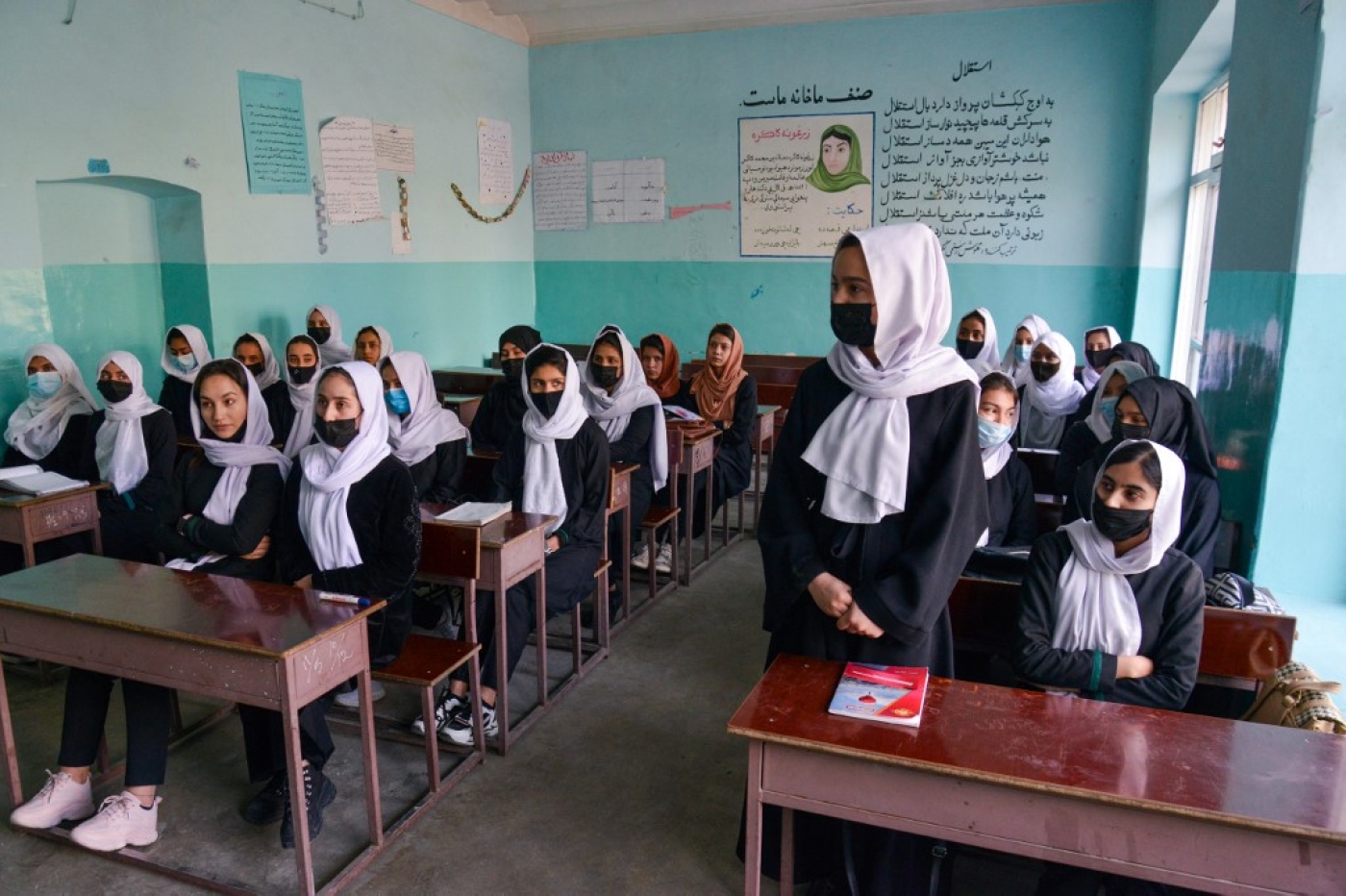 Girls attend a class after their school reopened in Kabul on 23 March 2022. The Taliban ordered girls' secondary schools in Afghanistan to shut just hours later (AFP)