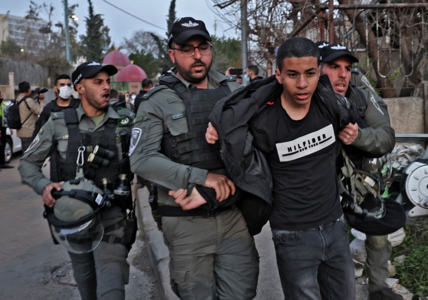 Israeli security forces detain a demonstrator during a protest in the flashpoint neighbourhood of Sheikh Jarrah in Israeli-annexed East Jerusalem, 18 February 2022 (AFP)