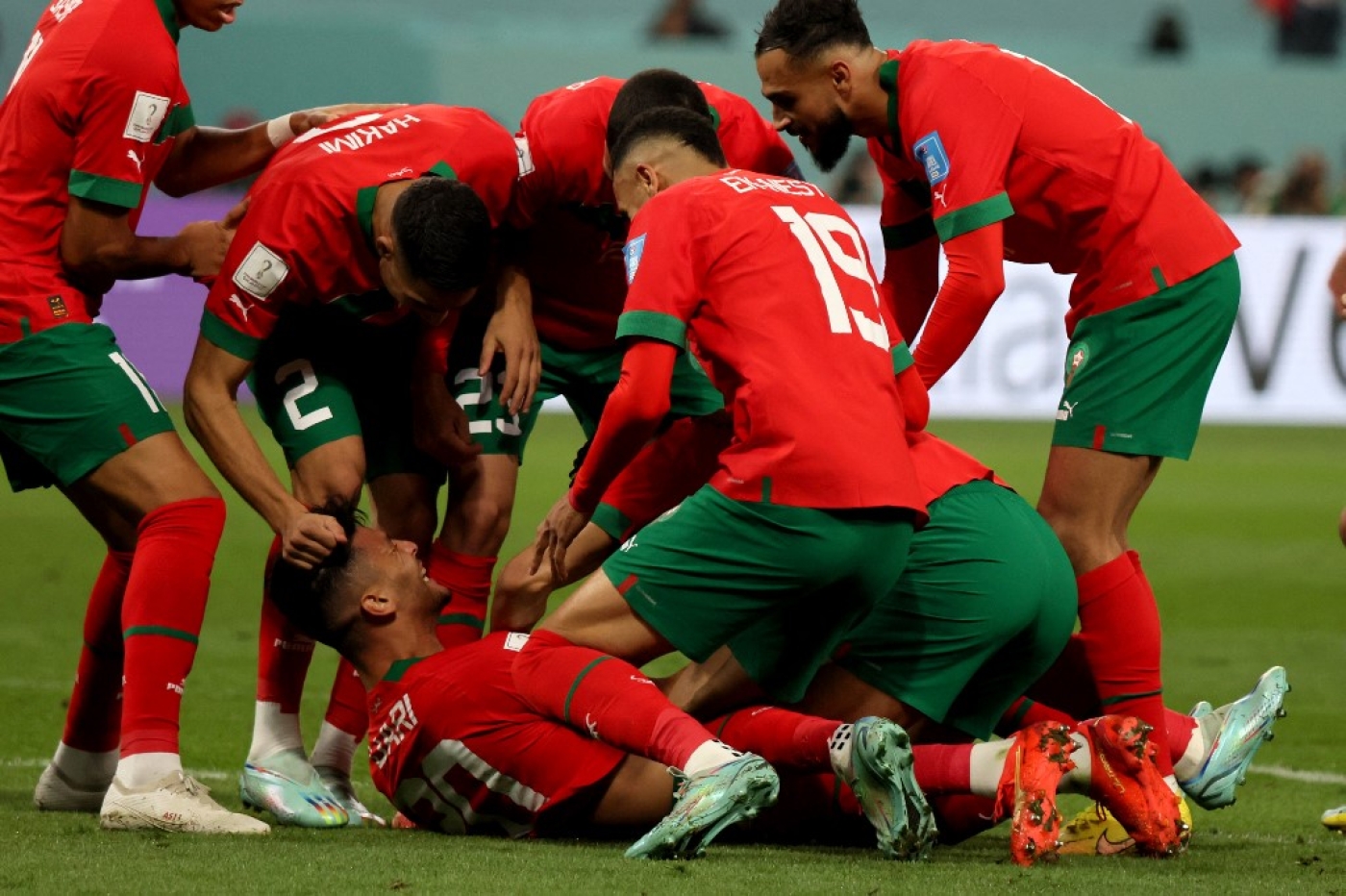 Morocco's Achraf Dari (C) is mobbed by his teammates after scoring in the third place play-off match against Croatia at Khalifa International Stadium, Doha on 17 December 2022 (AFP)