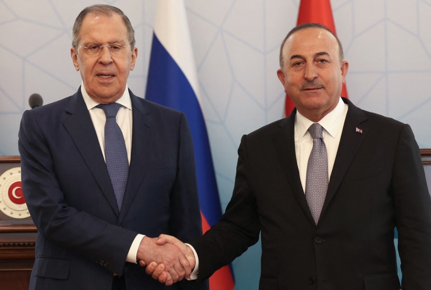 Russian Foreign Minister Sergei Lavrov (L) and Turkish Foreign Minister Mevlut Cavusoglu (R) shake hands after a news conference in Ankara, on 8 June 2022 (AFP)