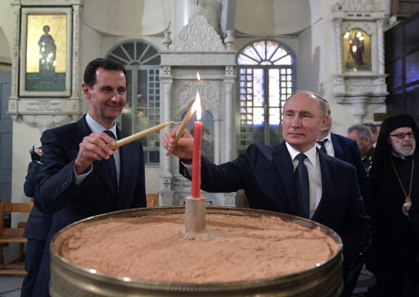 Russian President Vladimir Putin (R) and Syrian President Bashar al-Assad (L) visit the Mariamite Cathedral of Damascus, in the Syrian capital, 7 January 2020 (AFP)