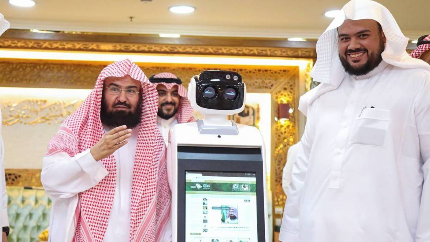 Abdul Rahman Al-Sudais, the general president of the Two Holy Mosques in Saudi Arabia, gestures while launching the new set of robots (Twitter/@ReasahAlharmain)
