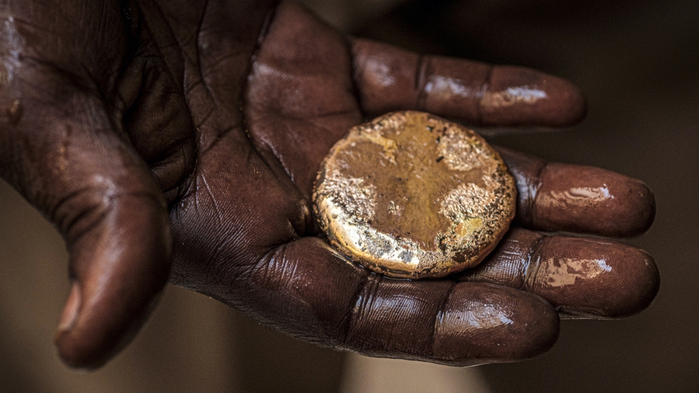 A jewellery craftsman holds a piece of gold at Khartoum's gold market in Sudan on 20 June 2019 (AFP)