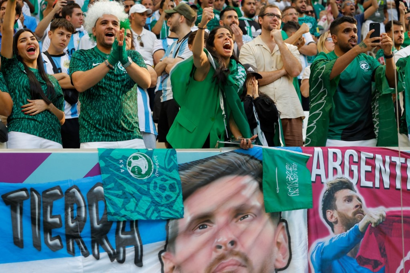 Saudi Arabia fans celebrate their team's victory during the Qatar 2022 World Cup Group C match between Argentina and Saudi Arabia at the Lusail Stadium, north of Doha, on 22 November 2022 (AFP)