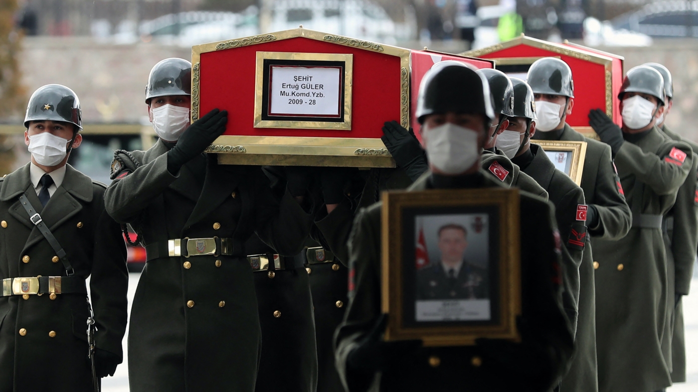 The coffins of three Turkish military personnel killed during clashes with Kurdish militants in Iraq's are carried during funeral prays at the Ahmet Hamdi Akseki Mosque in Ankara on 12 February 2021 (AFP) 