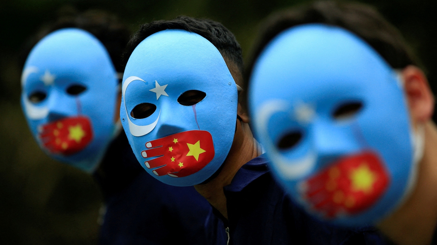 Activists take part in a protest against China's treatment towards the ethnic Uyghur people and calling for a boycott of the 2022 Winter Olympics in Beijing, at a park Jakarta, Indonesia, 4 January, 2022 (REUTERS)