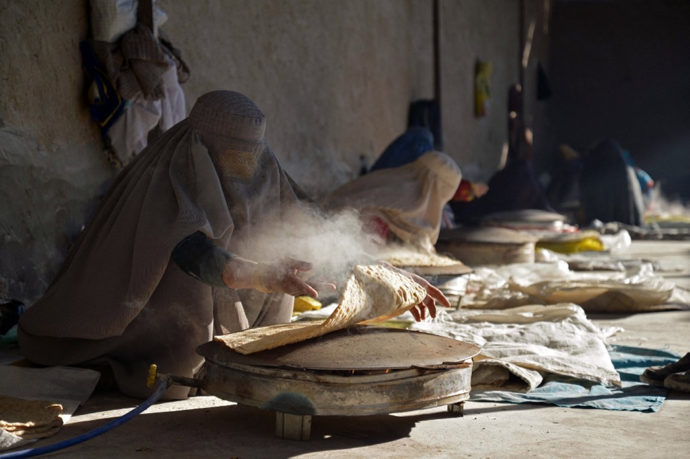 Afghan women workers prepare bread at a workplace to sell in a market in Kandahar on January 5, 2023. (AFP)