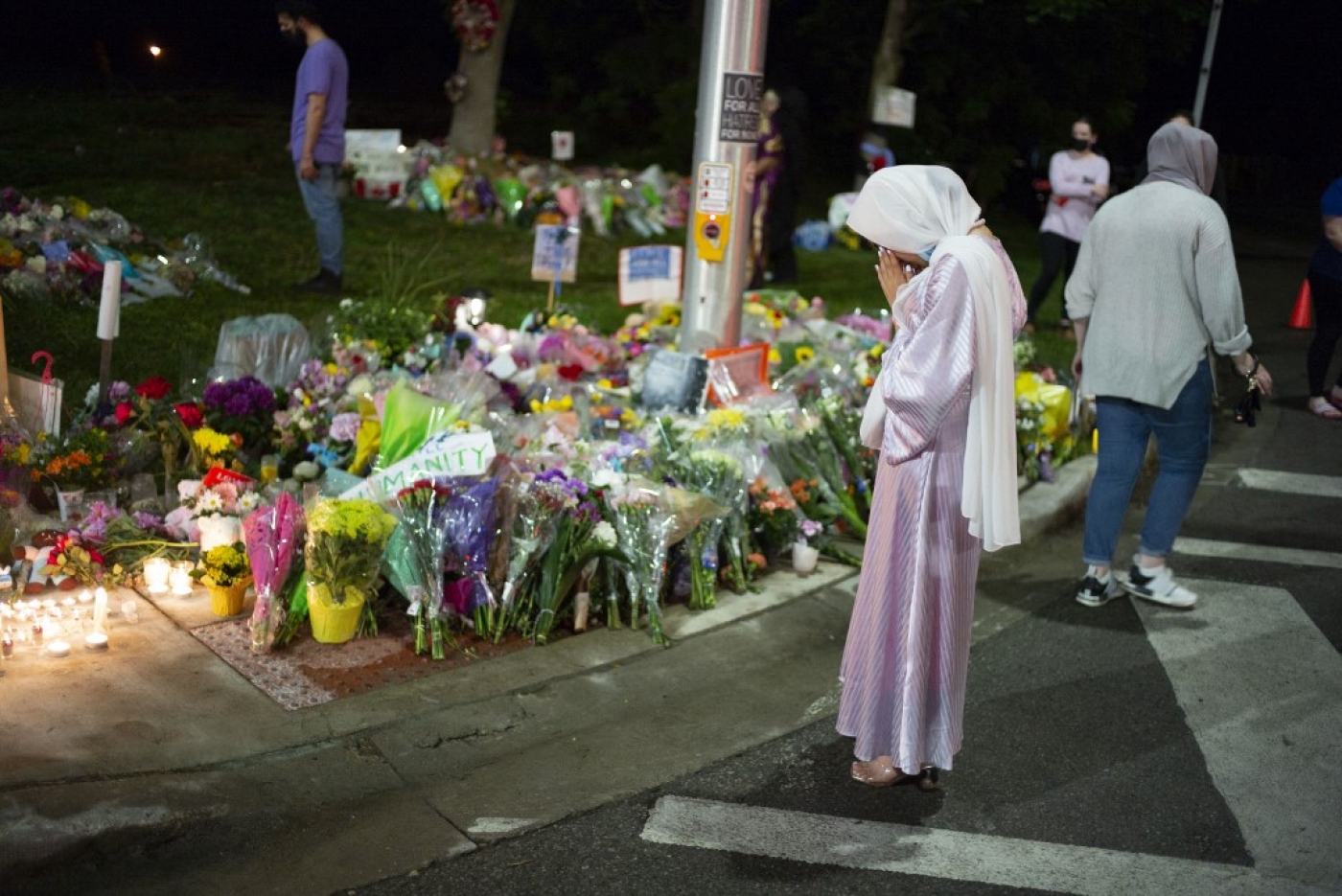 Members of the Muslim community and supporters light candles and place flowers at a memorial on 8 June in London, Canada.