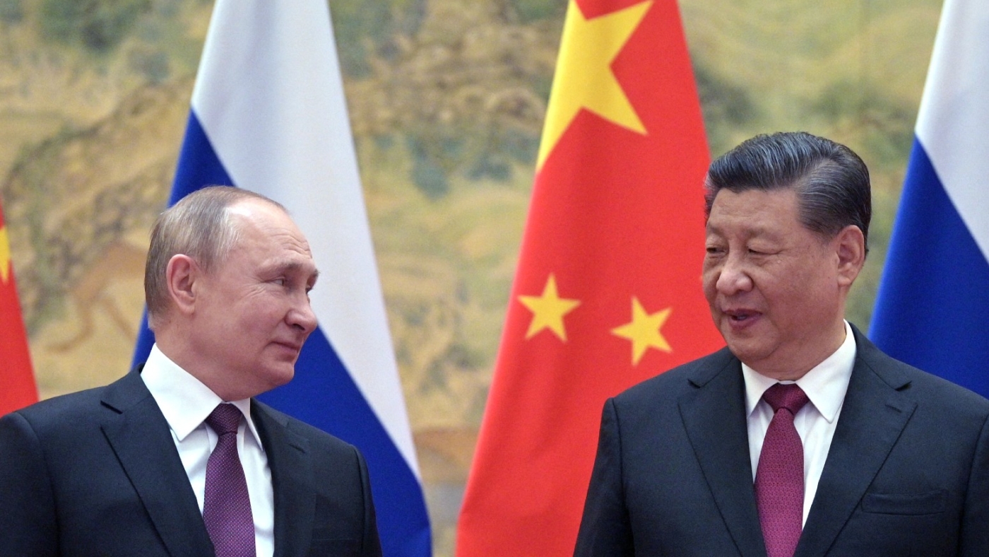 Russian President Vladimir Putin (L) and Chinese President Xi Jinping arrive to pose for a photograph during their meeting in Beijing, on 4 February, 2022 (AFP)