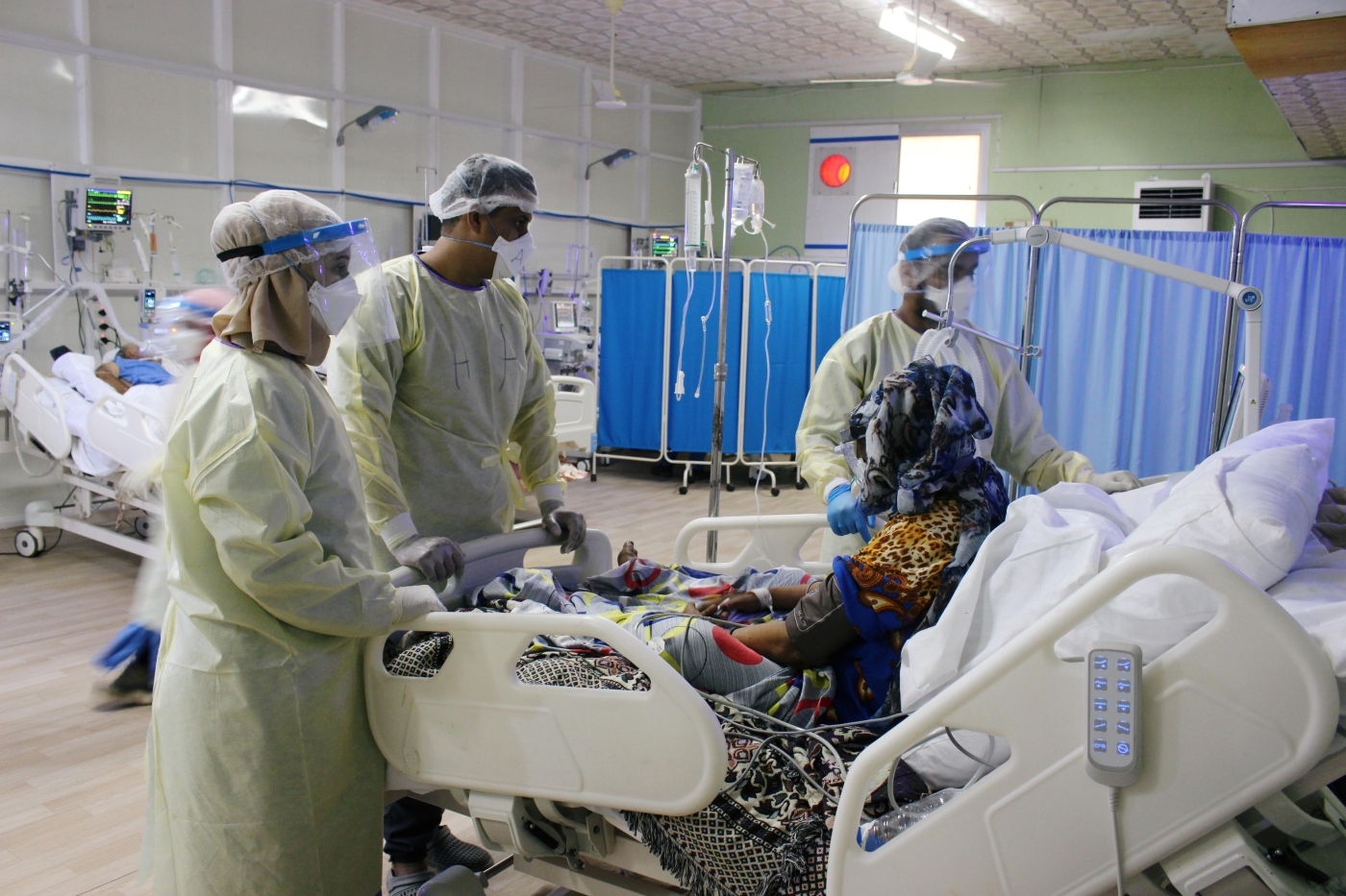 Doctors attend to a patient infected with the coronavirus disease in Aden, Yemen in June.