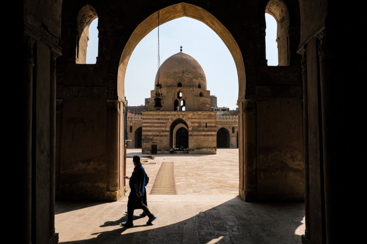 Visitors walk at the ninth-century mosque of Ibn Tulun in the historic quarter of the Egyptian capital Cairo on 4 May 2022. (AFP)