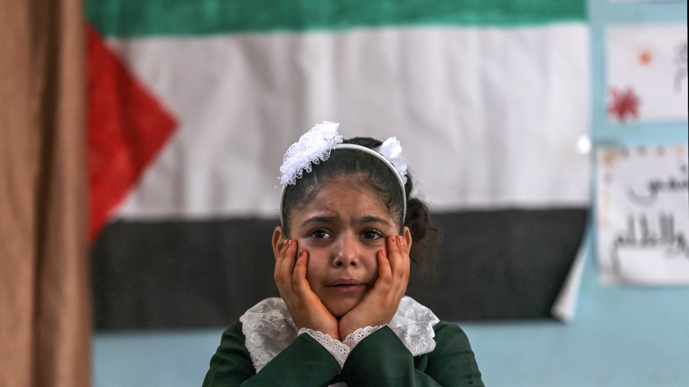 A classmate of Palestinian girl Lian al-Shaer, who was killed in an Israeli air strike during the latest Israeli attack mourns her death on the first day of school after the summer holiday, in Khan Yunis in the southern Gaza Strip, on 29 August, 2022 (AFP)
