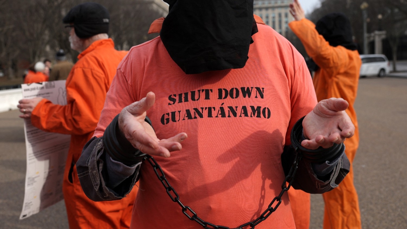 Activists in orange jumpsuits, representing the men who are still being held in Guantanamo Bay, participate in a protest in front of the White House on 11 January 2023.
