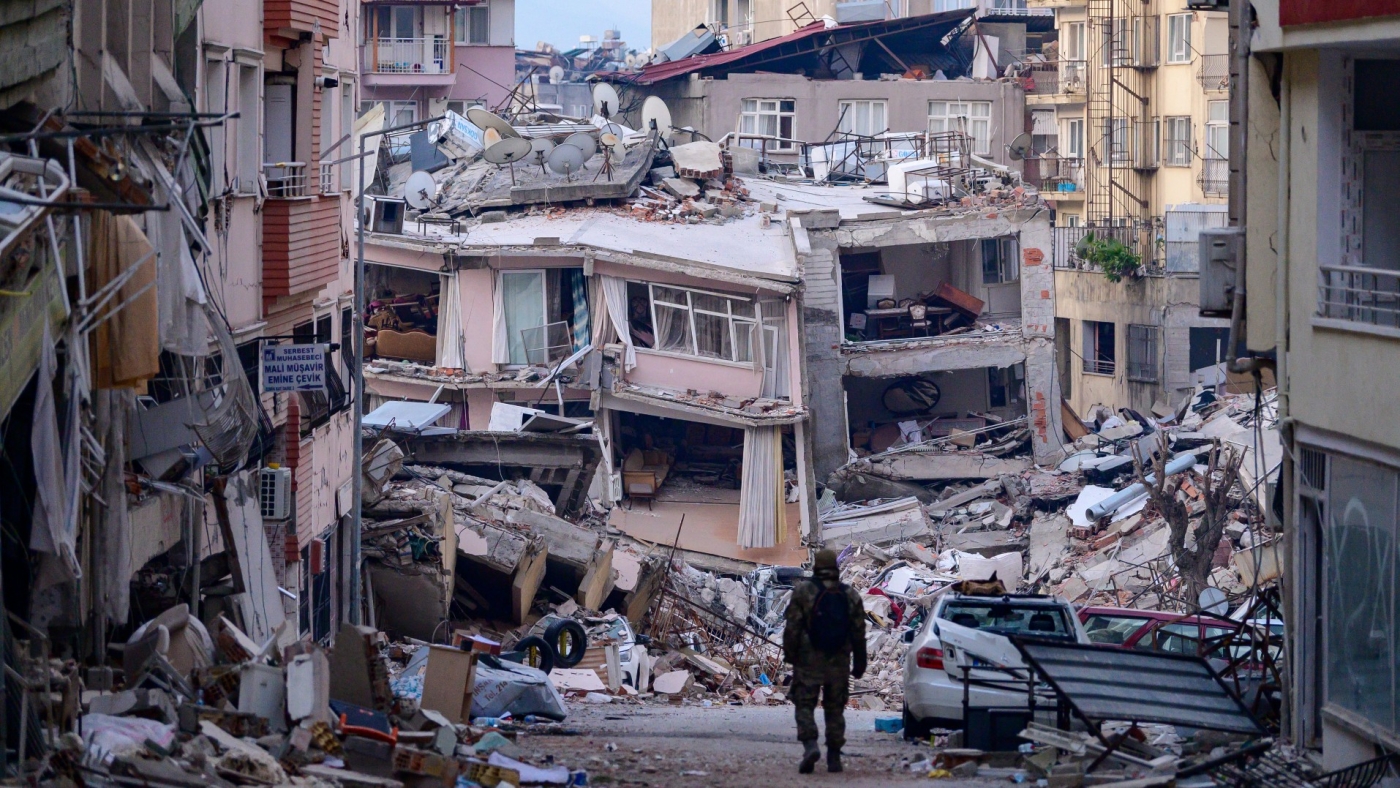 A soldier walks among destroyed buildings in southeast Turkey's Hatay province on 12 February 2023 (AFP)