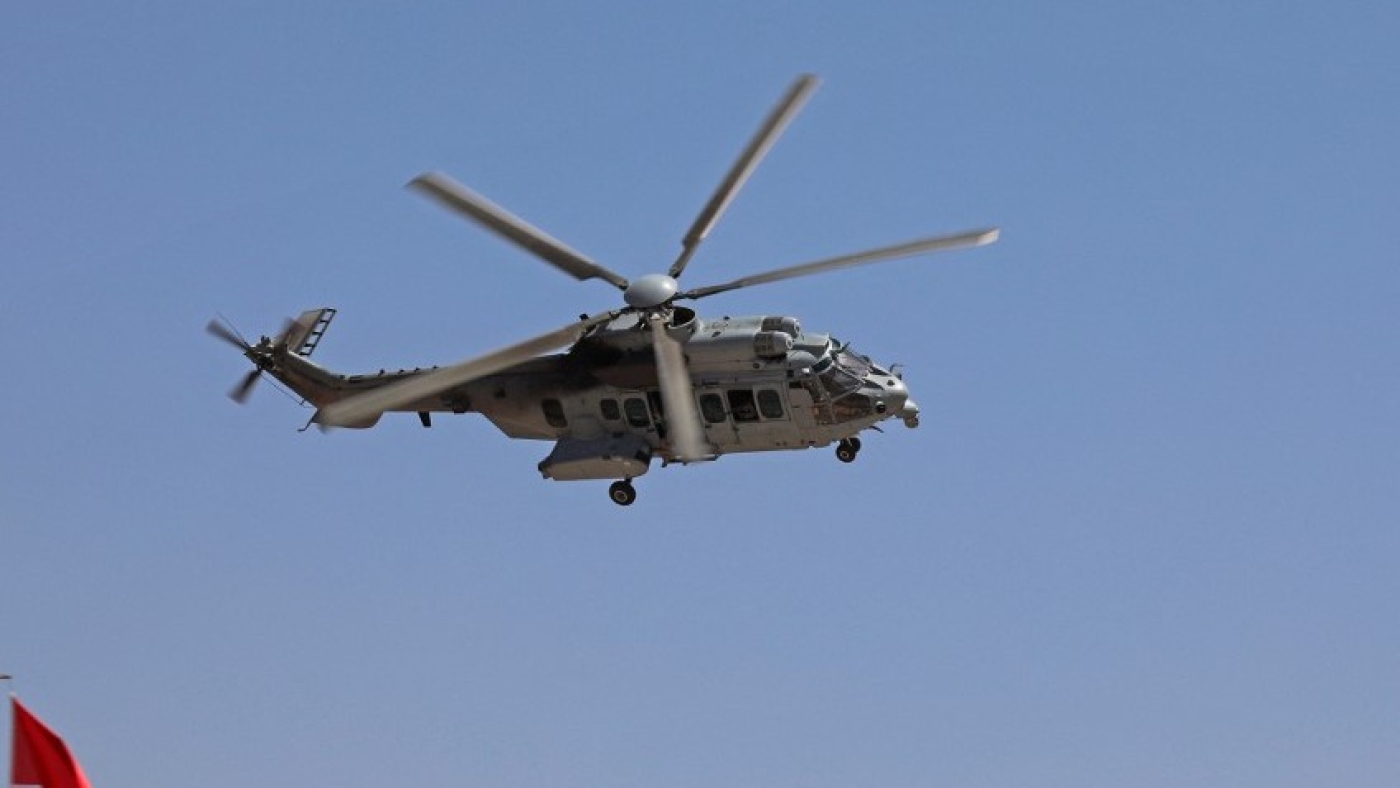 An AS332 Super Puma military helicopter flies during a graduation ceremony for Iraqi Kurdish Peshmerga officers in Arbil, the capital of Iraq's northern autonomous Kurdish region, on 21 June 2021 (AFP)