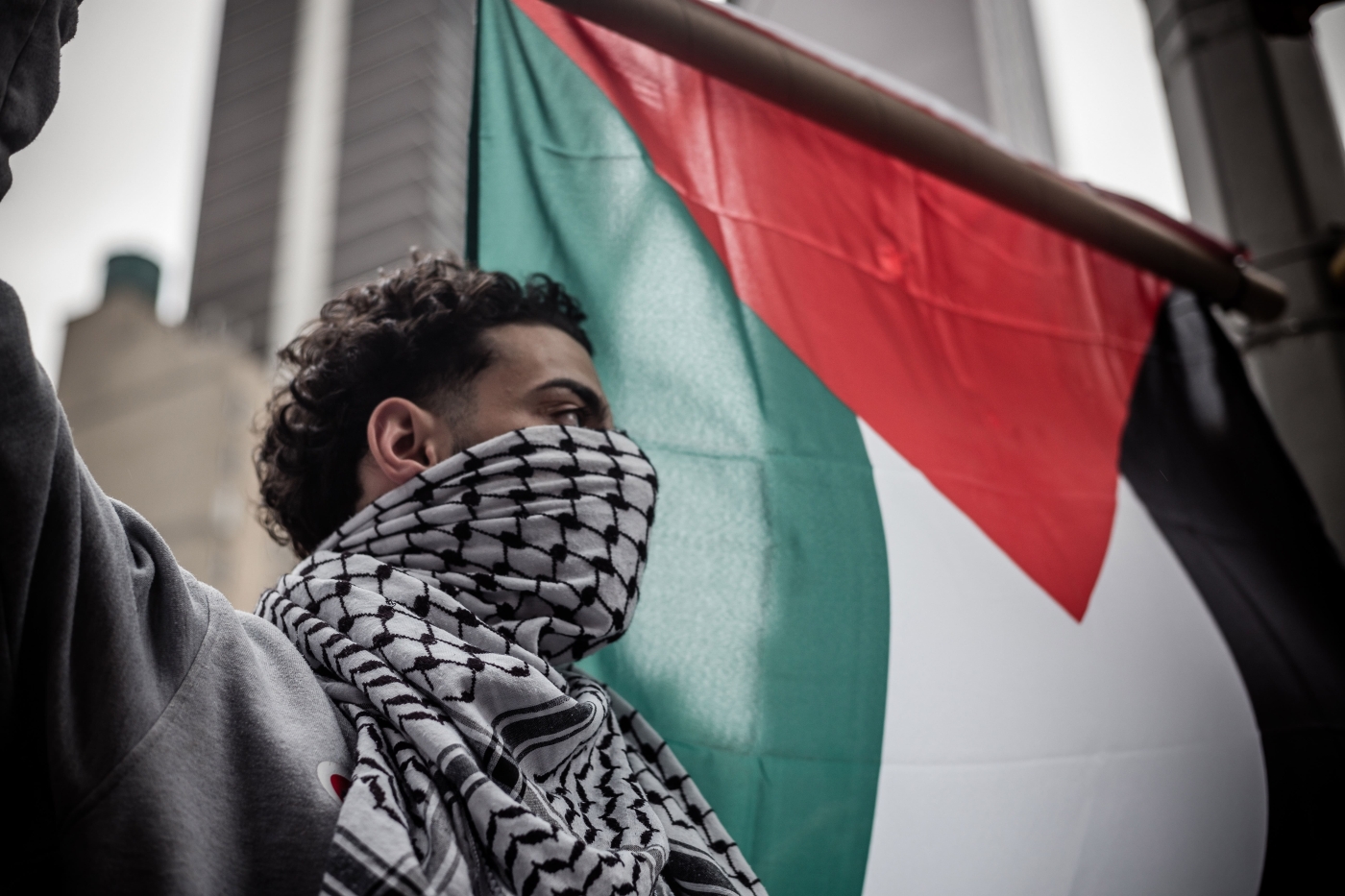 A demonstrator holds the Palestinian flag during a protest in New York city on 13 May 2022. (Reuters)
