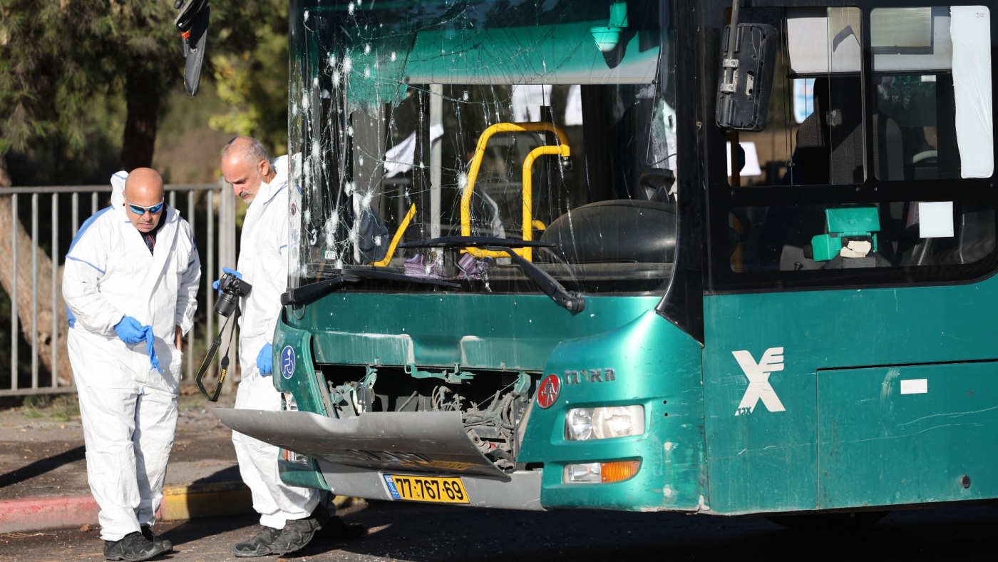 Israeli forensic experts work at the scene of an explosion at a bus stop in Jerusalem on 23 November 2022 (AFP)