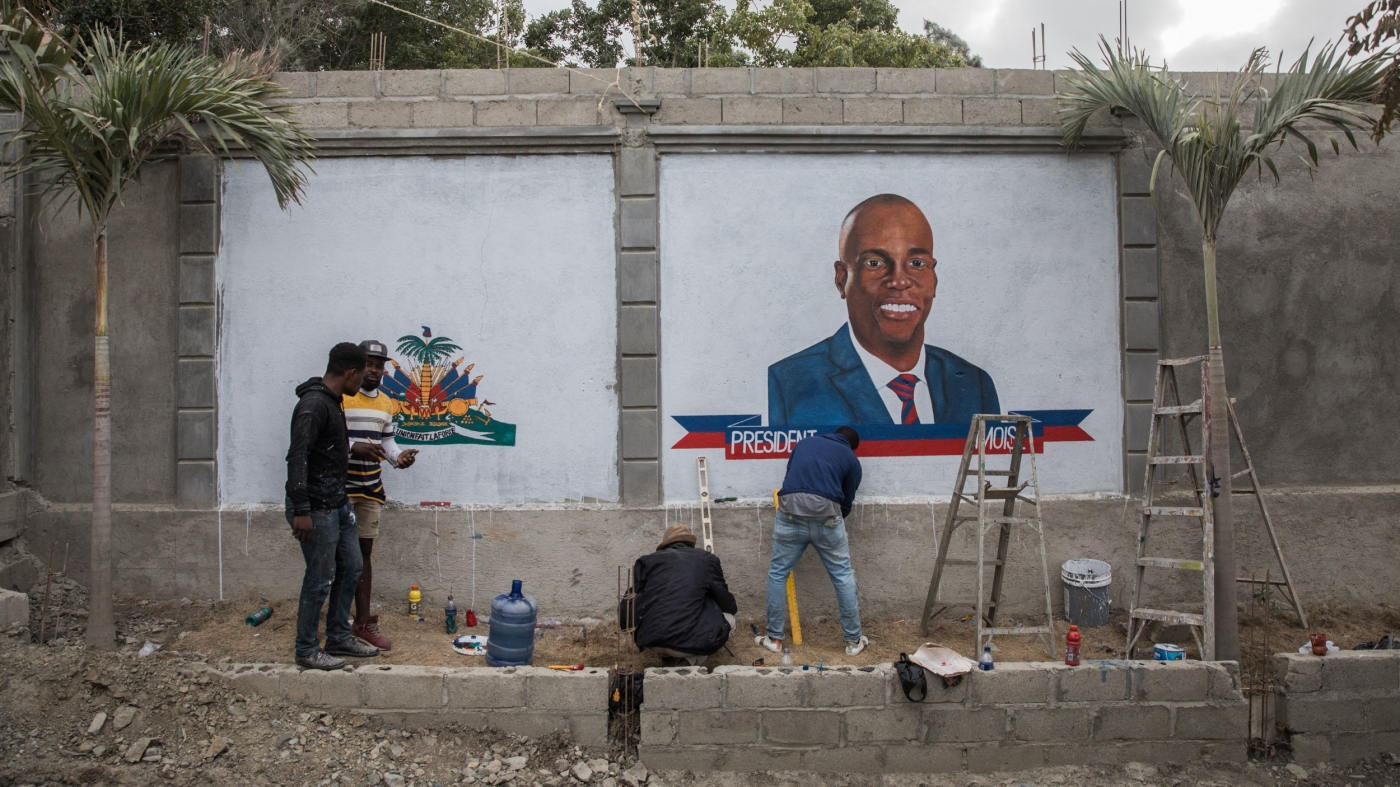 Local artists paint murals in tribute to Jovenel Moise in front of the place where he was buried in Cap-Haitien ahead of his funeral in July 2021 (AFP)