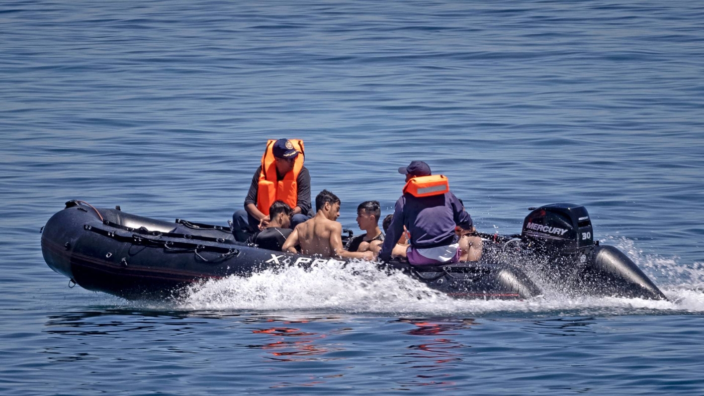 Royal Moroccan Navy officers intercept people in the water at the border between Morocco and the Spanish enclave of Ceuta on 19 May 2021.