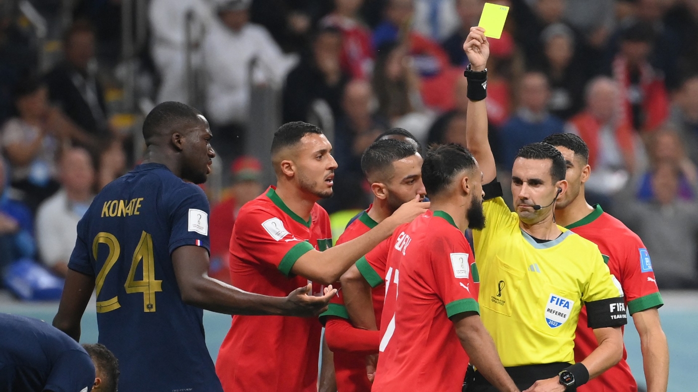 Mexican referee Cesar Ramos shows a yellow card to Morocco's Sofiane Boufal during the World Cup semi-final football match against France at Al-Bayt Stadium in Al Khor, north of Doha on 14 December 2022 (AFP)