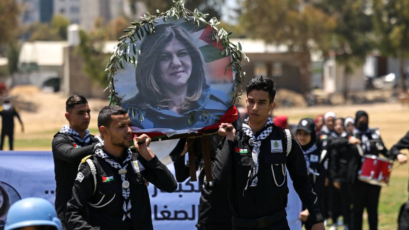 Palestinian youths hold a mock funeral for slain Al-Jazeera reporter Shireen Abu Akleh in Gaza City on 17 May 2022