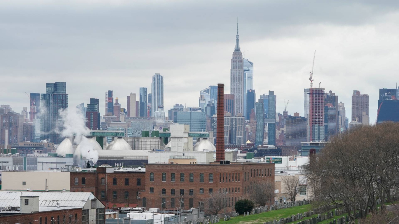 The Manhattan skyline rises over Calvary Cemetery in the Borough of Queens on 31 March 2020 in New York.