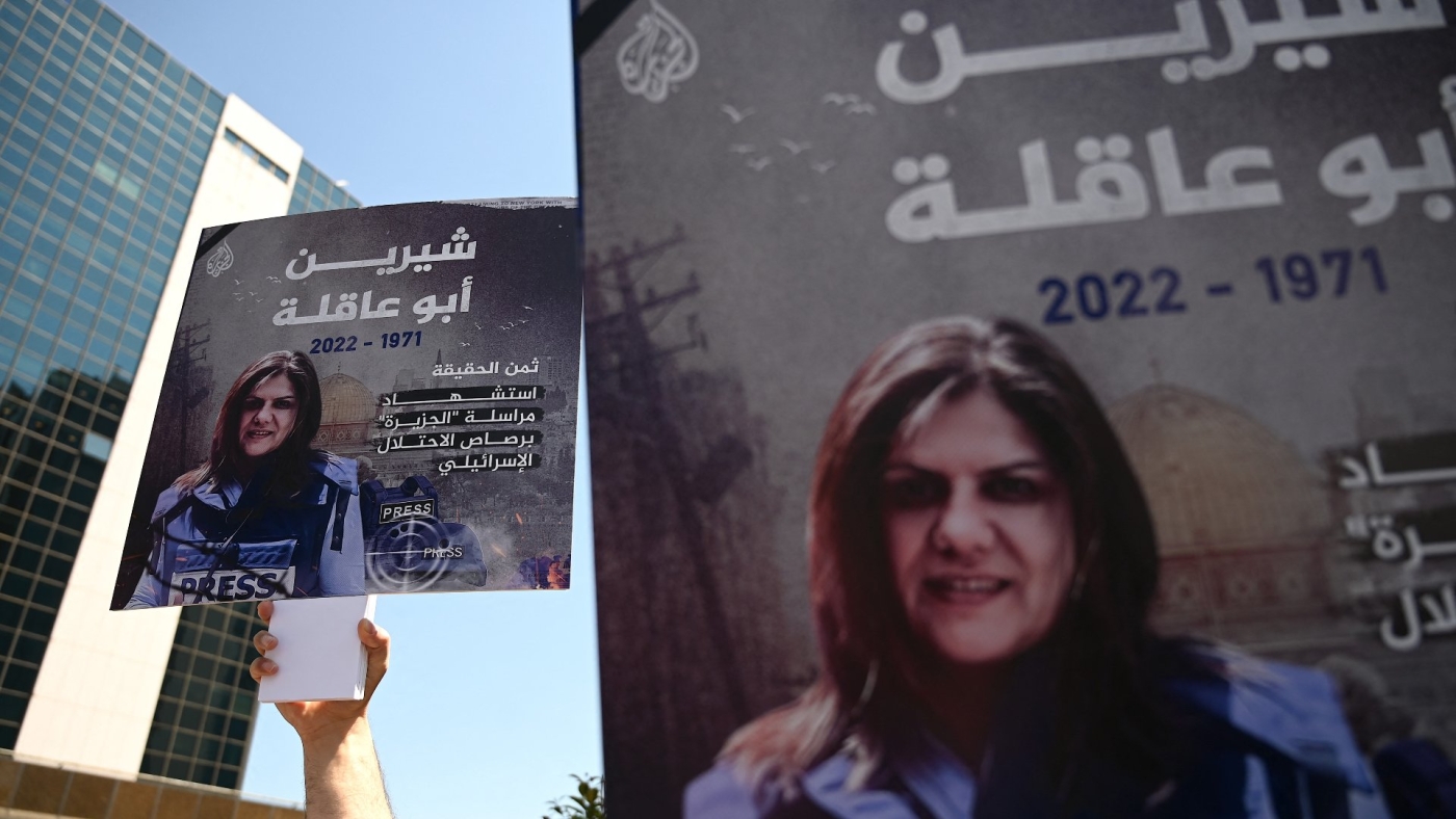 Journalists carry posters of Palestinian journalist Shireen Abu Akleh as they gather to condemn her death in front of Israel consulate in Istanbul on 12 May 2022.