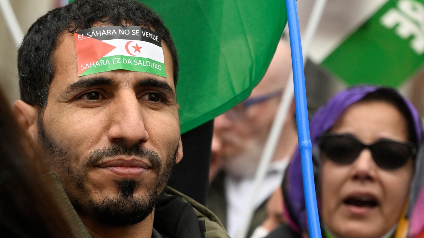 A demonstrator with a banner reading "Sahara is not for sale" during a protest against the Spanish government support for Morocco's autonomy plan for Western Sahara, in Madrid, on 26 March 2022 (AFP) 