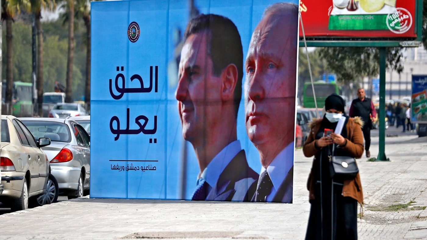 A banner depicting Syrian President Bashar al-Assad and Russian President Vladimir Putin and reading "Justice Prevails", is displayed along a highway in Damascus, on 8 March 2022.
