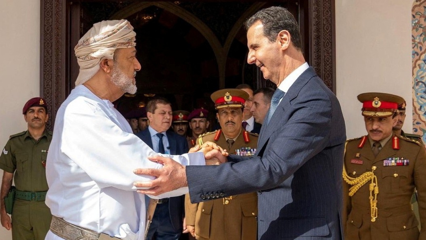 Oman's Sultan Haitham bin Tariq shakes hands with Syrian President Bashar al-Assad during his first trip abroad since the devastating earthquake in Syria, in Muscat, Oman, 20 February 2023 (Reuters)